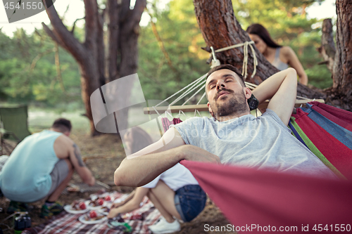 Image of Party, camping of men and women group at forest. They relaxing and cooking barbecue