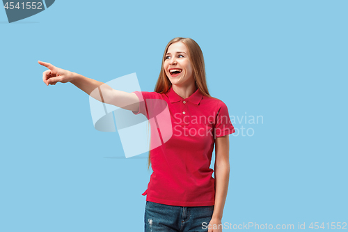 Image of The happy business woman point you and want you, half length closeup portrait on blue background.