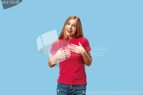 Image of The happy business woman standing and smiling against blue background.