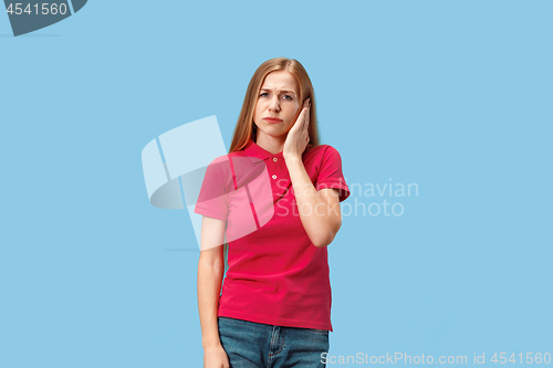 Image of Woman having headache. Isolated over blue background.