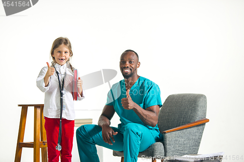 Image of healthcare and medical concept - doctor and girl with stethoscope in hospital