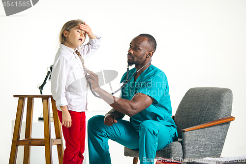 Image of healthcare and medical concept - doctor with stethoscope listening to child chest in hospital