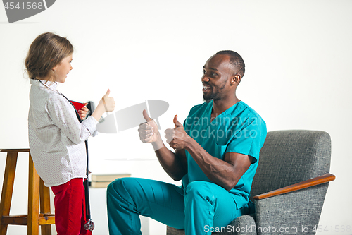 Image of healthcare and medical concept - doctor and girl with stethoscope in hospital