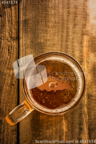 Image of turkish beer concept, Turkey silhouette on foam in beer glass on wooden table.