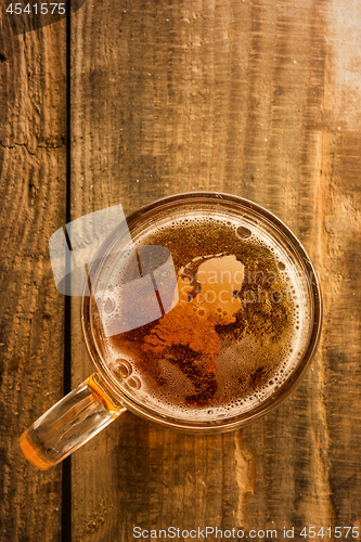 Image of Dutch beer concept, Netherlands silhouette on foam in beer glass on wooden table.