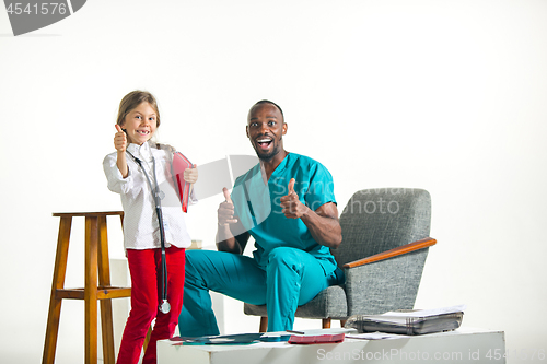 Image of healthcare and medical concept - doctor and girl with stethoscope in hospital