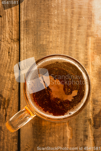 Image of Mexican beer concept, Mexico silhouette on foam in beer glass on wooden table.