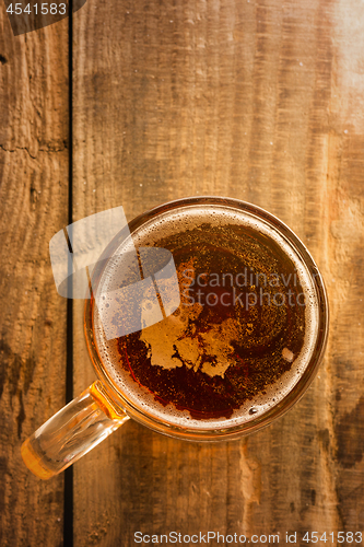 Image of Danish beer concept, Denmark silhouette on foam in beer glass on wooden table.