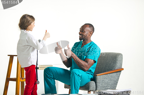 Image of healthcare and medical concept - doctor and girl with stethoscope in hospital