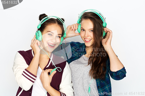Image of teenage girls in earphones listening to music