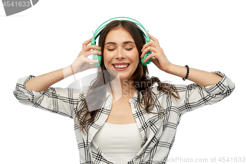 Image of happy young woman or teenage girl with headphones