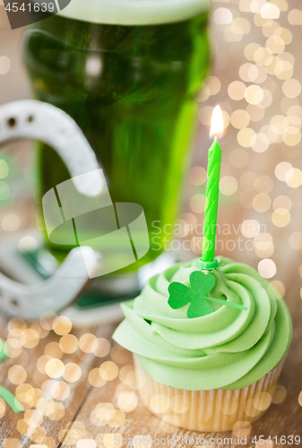 Image of green cupcake with candle, beer and horseshoe