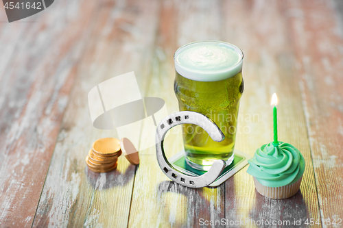 Image of glass of beer, cupcake, horseshoe and gold coins