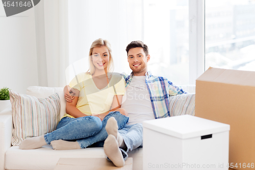 Image of happy couple with boxes moving to new home