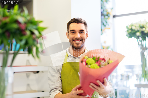 Image of smiling florist man with bunch at flower shop