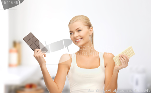 Image of woman choosing between dark and white chocolate