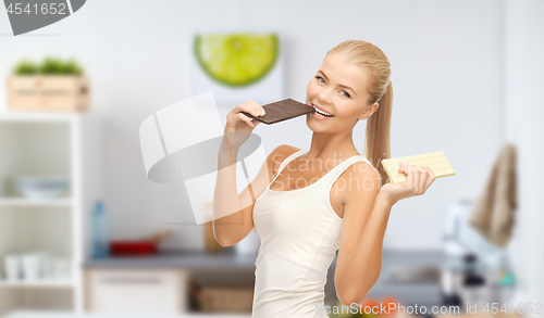 Image of happy woman eating dark chocolate instead of white