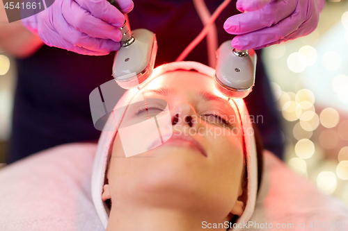 Image of young woman having face microdermabrasion at spa