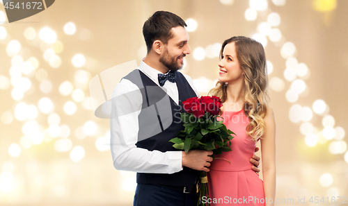 Image of couple with bunch of flowers on valentines day