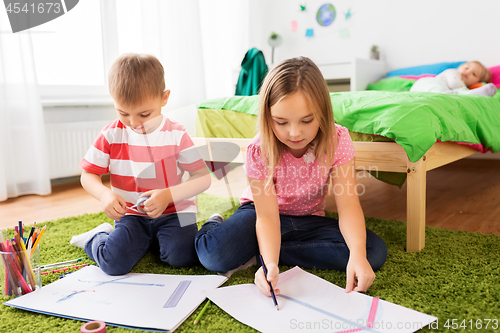 Image of children drawing and making crafts at home