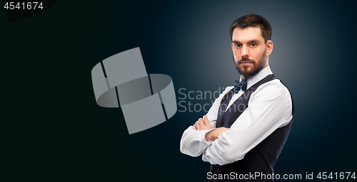 Image of man in shirt and bowtie over black background