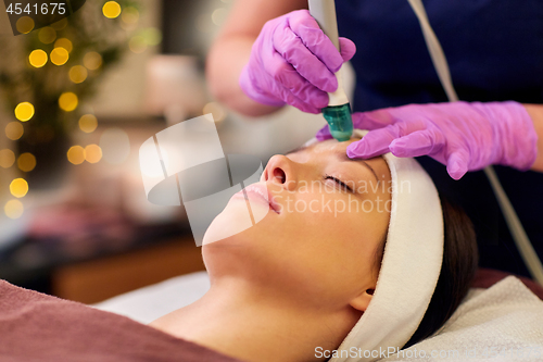 Image of woman having microdermabrasion facial treatment