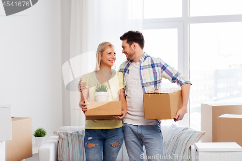 Image of happy couple with boxes moving to new home