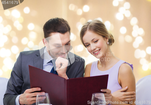 Image of couple with menu at restaurant