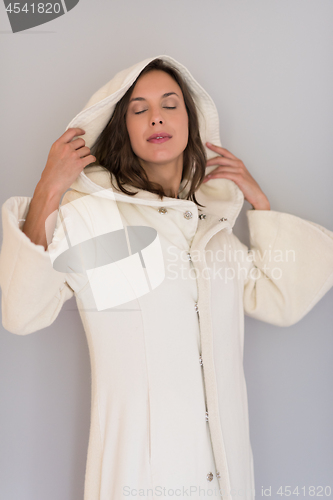 Image of woman in a white coat with hood isolated on white background