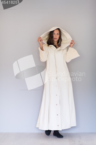 Image of woman in a white coat with hood isolated on white background