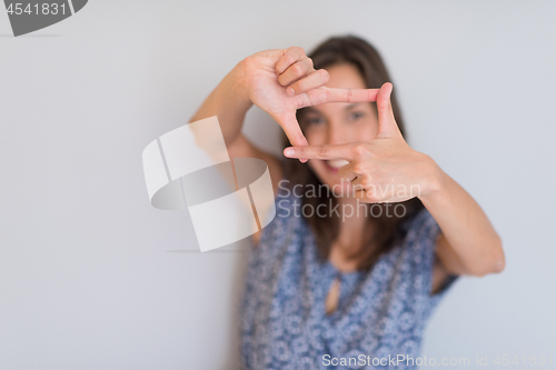 Image of woman showing framing hand gesture