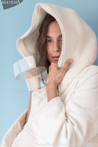 Image of woman in a white coat with hood isolated on blue background