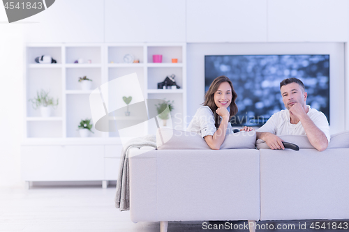 Image of Young couple on the sofa watching television