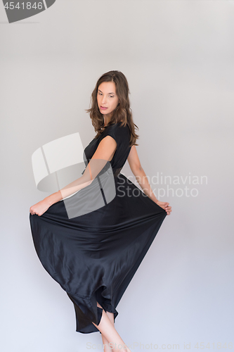 Image of woman in a black dress isolated on white background