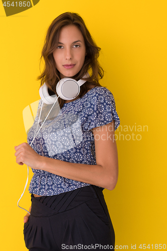 Image of woman with headphones isolated on a yellow