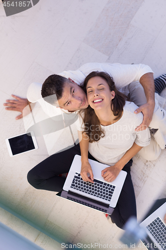 Image of couple using tablet and laptop computers top view