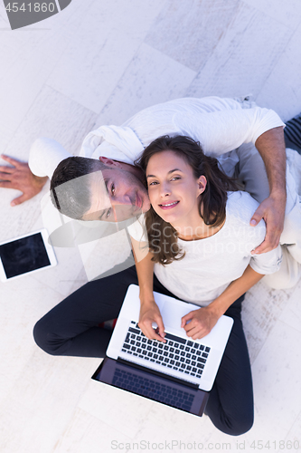 Image of couple using tablet and laptop computers top view