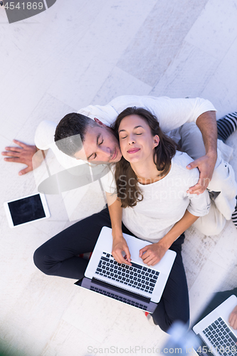 Image of couple using tablet and laptop computers top view