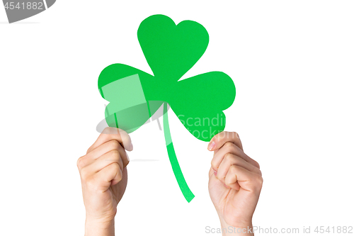 Image of hands holding green paper shamrock