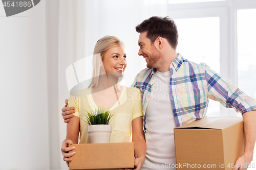 Image of happy couple with boxes moving to new home