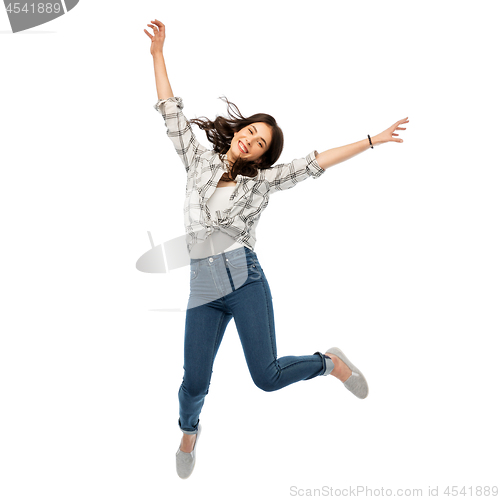 Image of happy young woman or teenage girl jumping