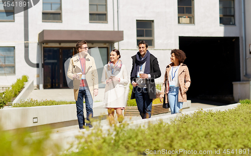 Image of office workers with coffee on city street