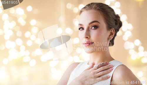 Image of woman in white dress with diamond jewelry