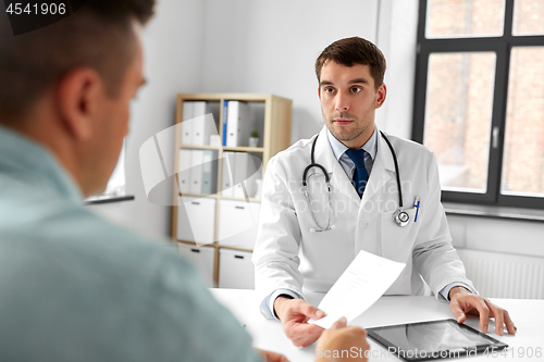 Image of doctor giving prescription to patient at hospital