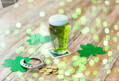 Image of glass of green beer, horseshoe and gold coins