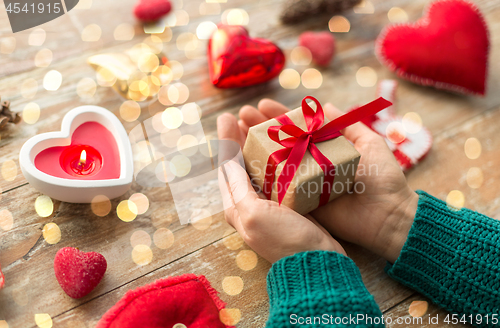 Image of close up of hands holding christmas gift