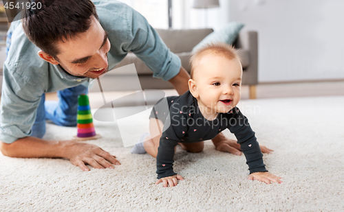 Image of happy little baby girl with father at home