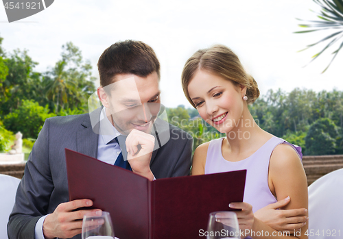 Image of couple with menu at restaurant