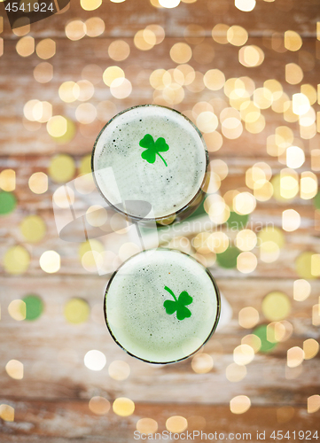 Image of glasses of green beer with shamrock from top