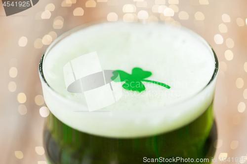 Image of close up of glass of green beer with shamrock